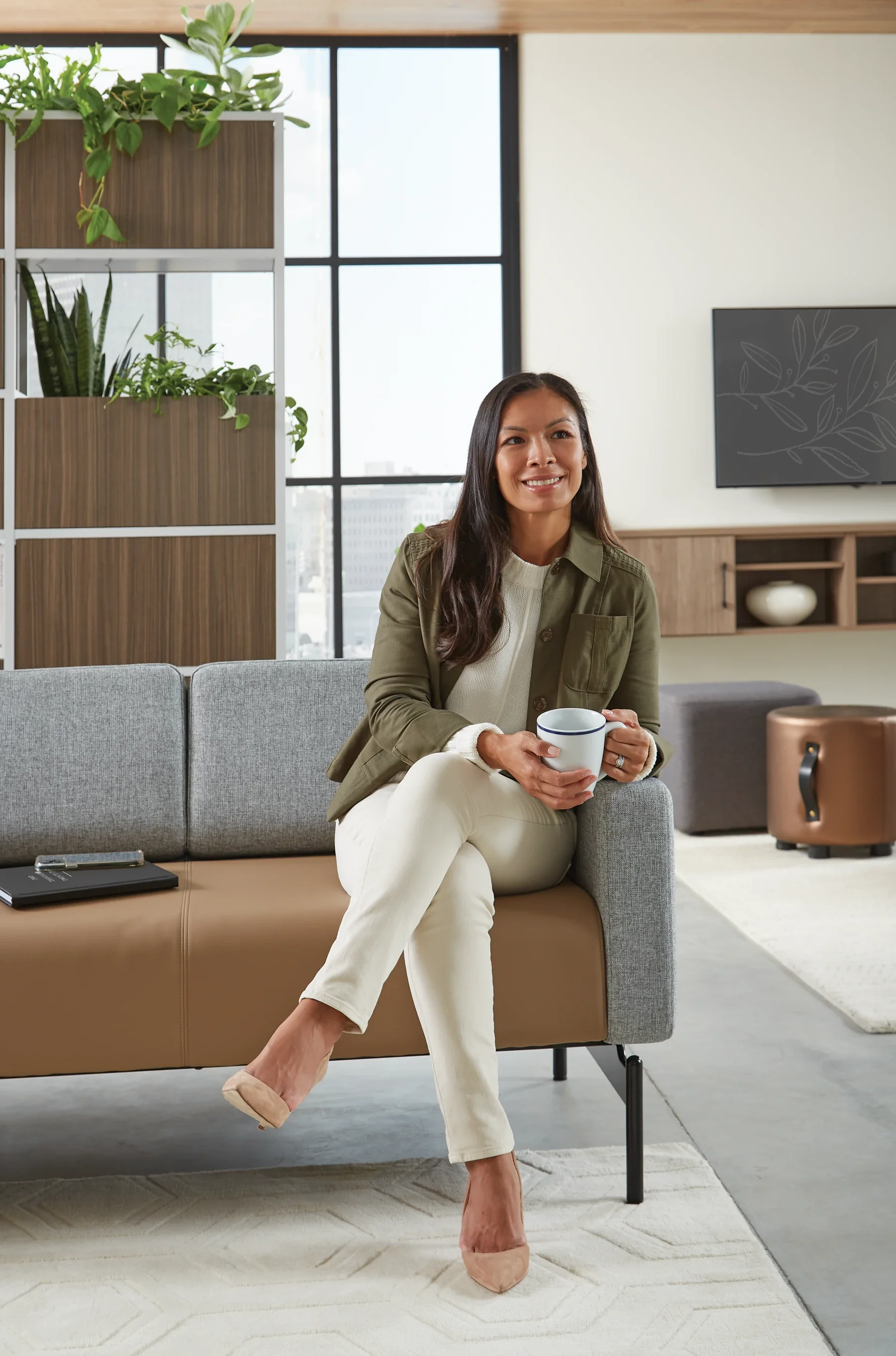A person seated in a comfortable collaborative lounge environment.