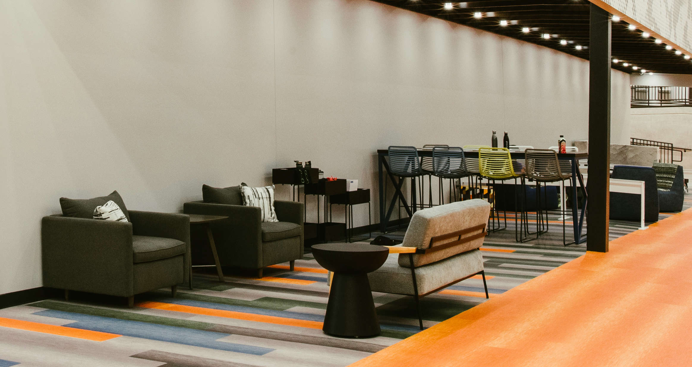Lounge seating and café tables in a flexible learning commons.