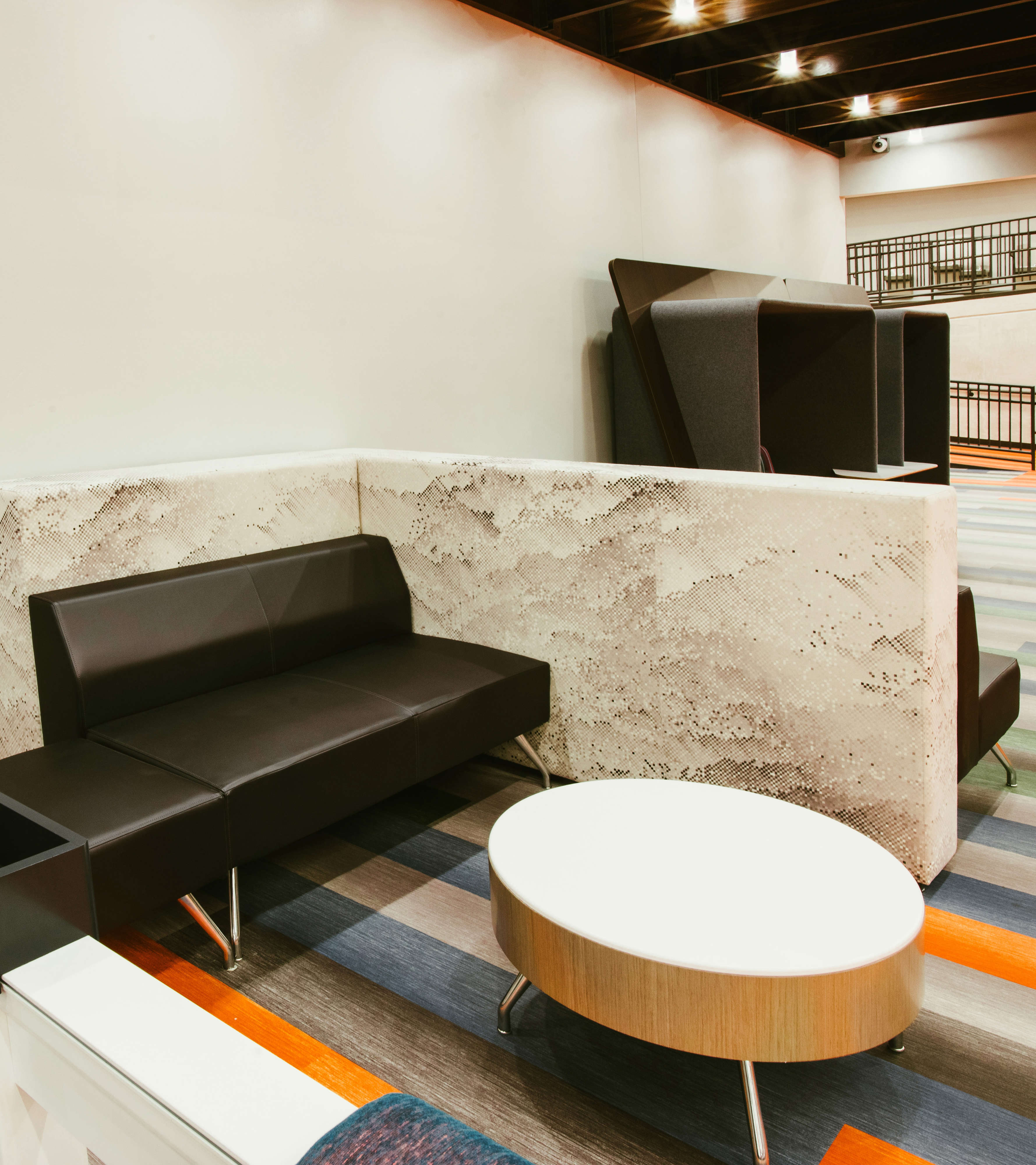 Built-in bench seating and round table in a learning commons.