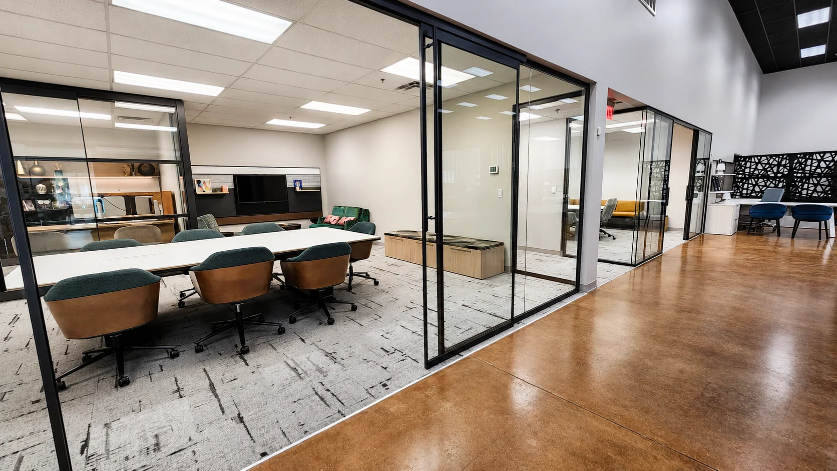 Glass conference room and open showroom aisle at Pettus Interiors in Little Rock