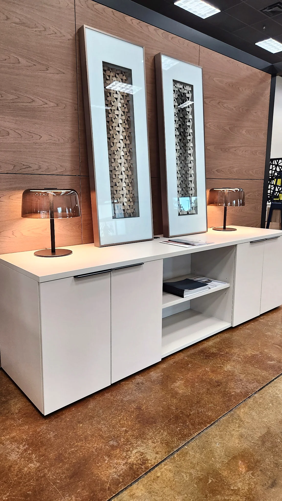 Display credenza, lighting, and wall art in the Pettus Interiors Little Rock showroom