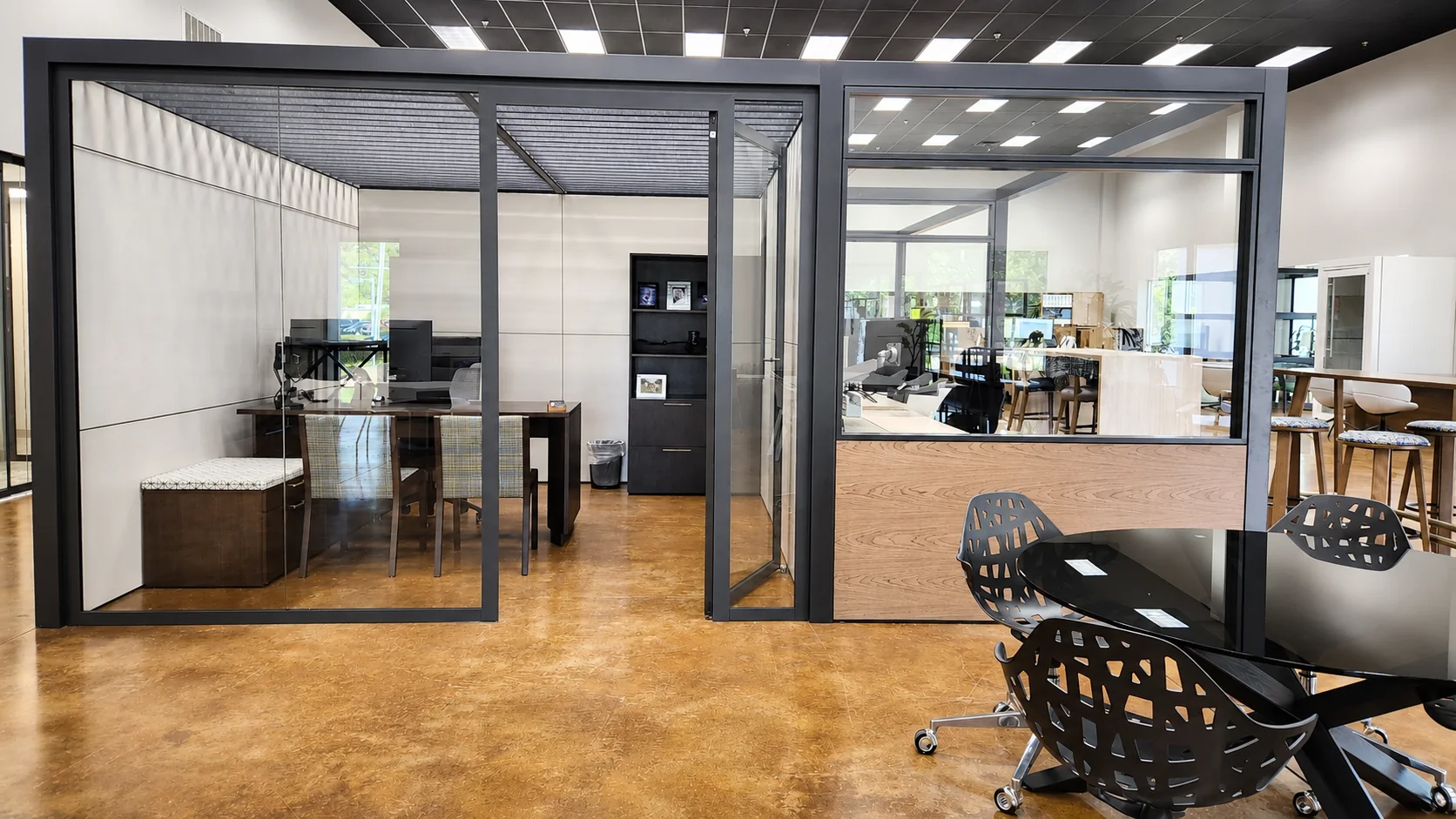 Glass-walled office and meeting furniture in the Pettus Interiors Little Rock showroom
