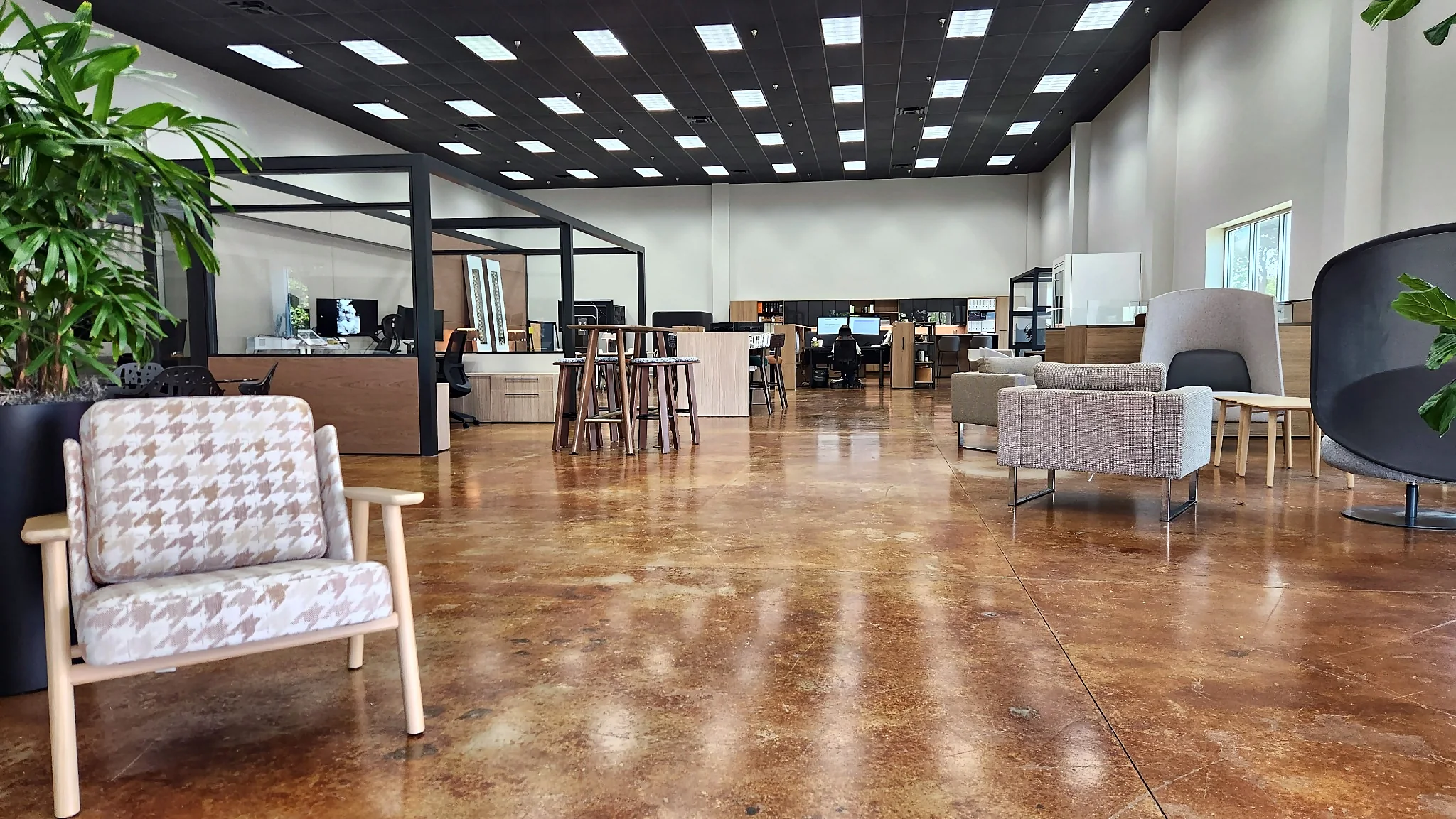 Wide floor view of lounge seating and workplace displays in the Pettus Interiors Little Rock showroom