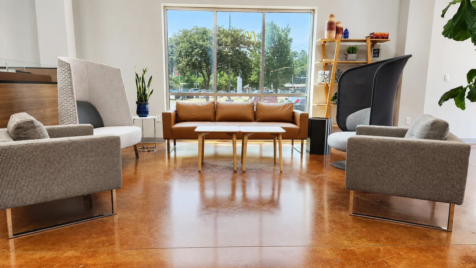 Lounge chairs and tables arranged by the windows in the Pettus Interiors Little Rock showroom