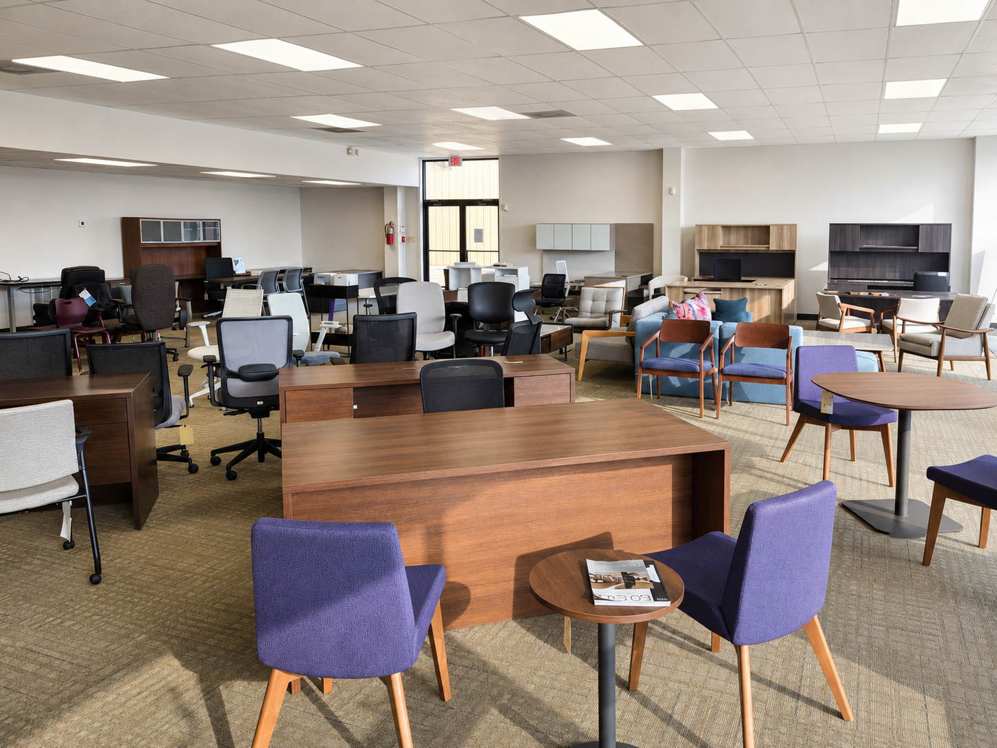 Desks, office chairs, lounge seating, and meeting tables in the Pettus Interiors Monroe showroom