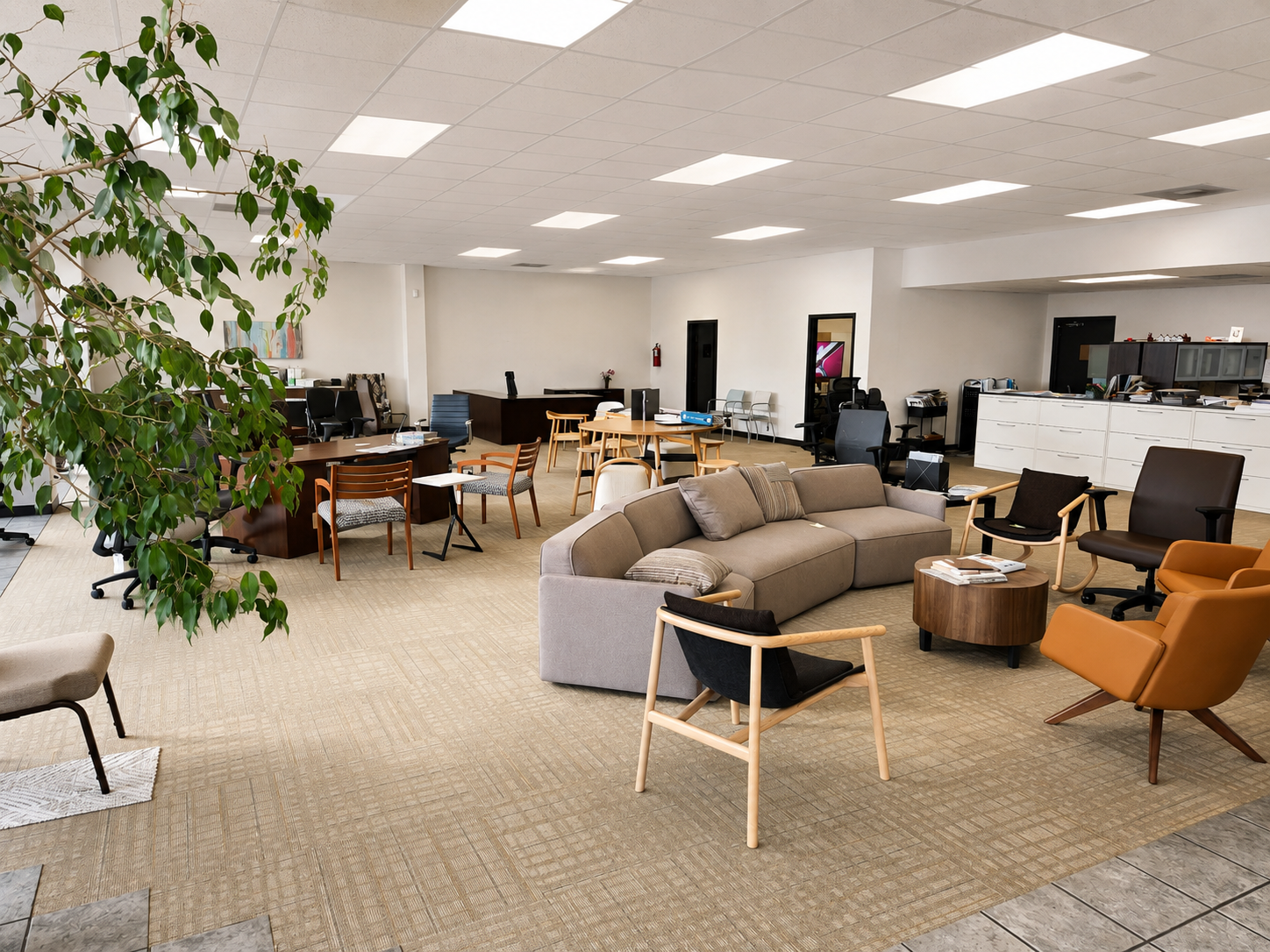 Lounge furniture, office chairs, desks, and tables in the Pettus Interiors Monroe showroom
