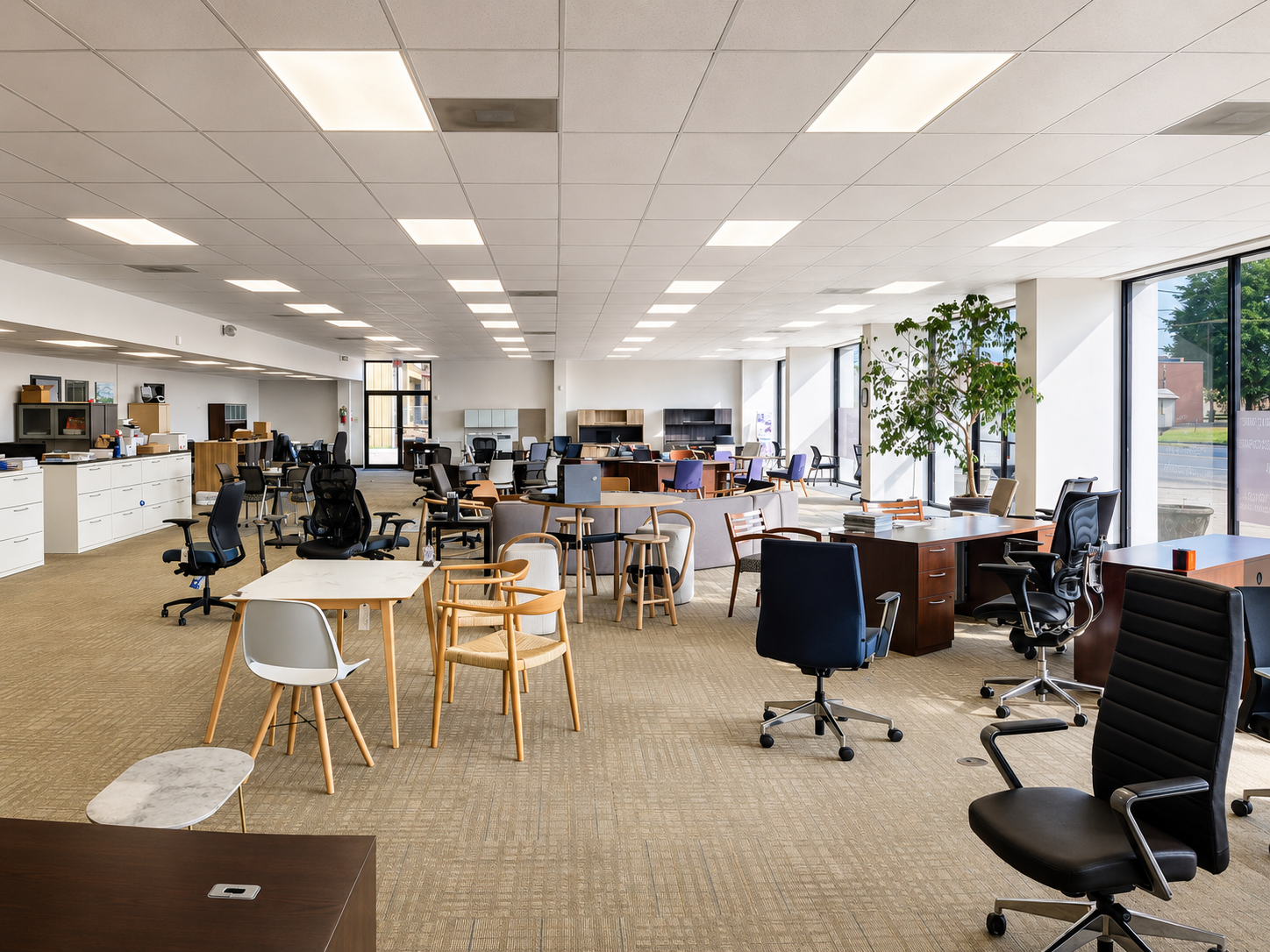 Wide view of the Pettus Interiors Monroe showroom with office chairs, desks, tables, and lounge furniture