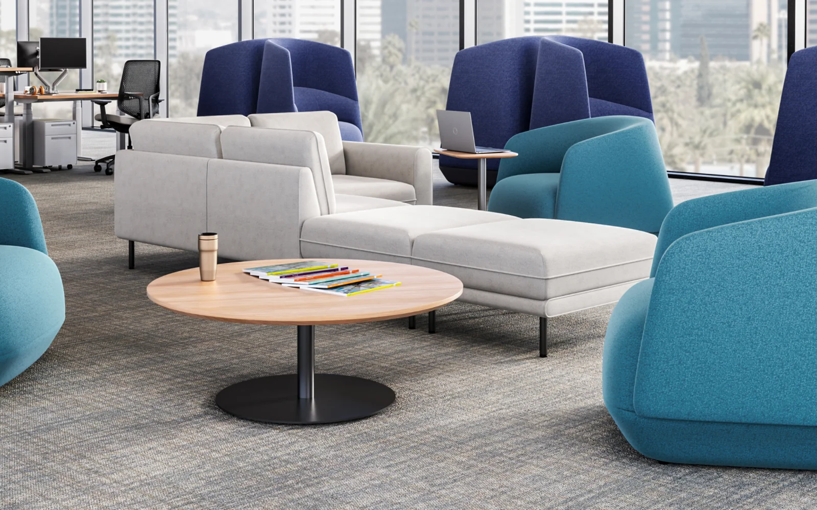 Teal SitOnIt lounge chairs and white sofas around a wood table, with tall blue privacy-back chairs beyond